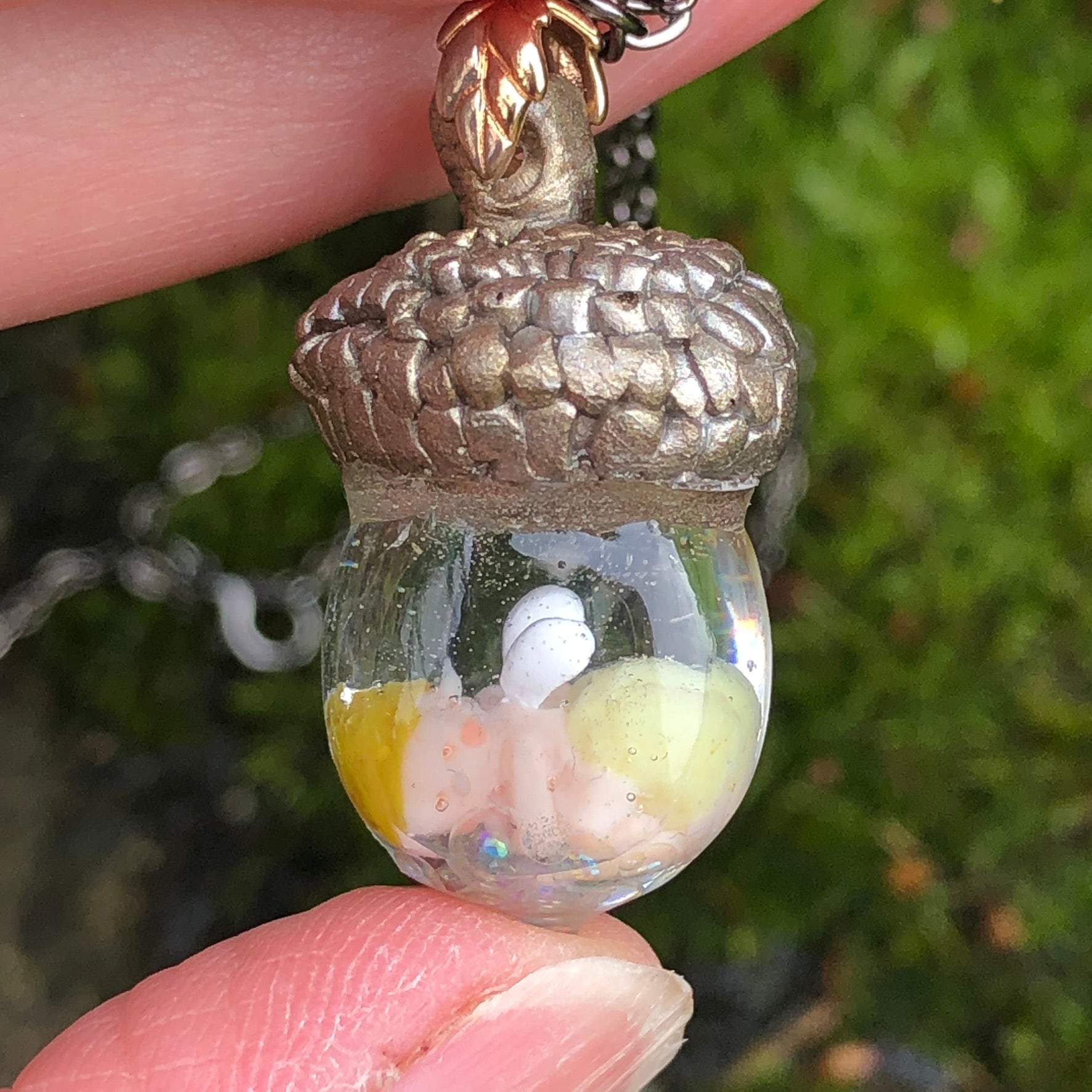 Hand-sculpted Acorn Fairy Baby with optional nappy colour keepsake NecHand-sculpted Acorn Fairy Baby with optional nappy colour keepsake Necklace Gift
🍄✨ Introducing our Hand Sculpted Acorn Fairy Baby Encapsulated in Crystal Clear ResnecklacePadpod & BerrieMy Fairytale GiftsHand-sculpted Acorn Fairy Baby