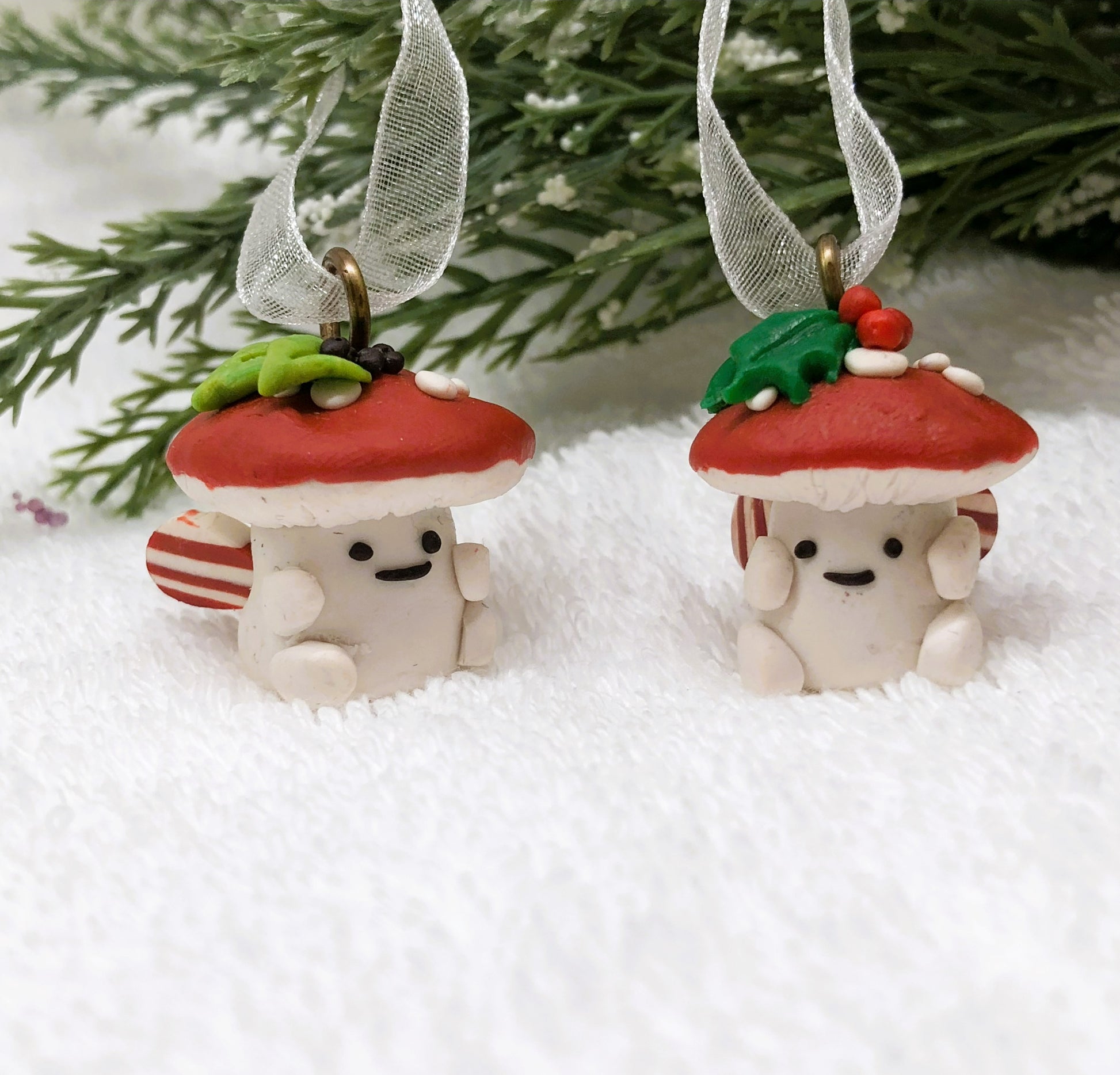 Introducing our Holly & Ivy cute candy cane winged Mushroom charms handmade in polymer clay, to dangle as home decor or thread on a cord to wear as a necklace