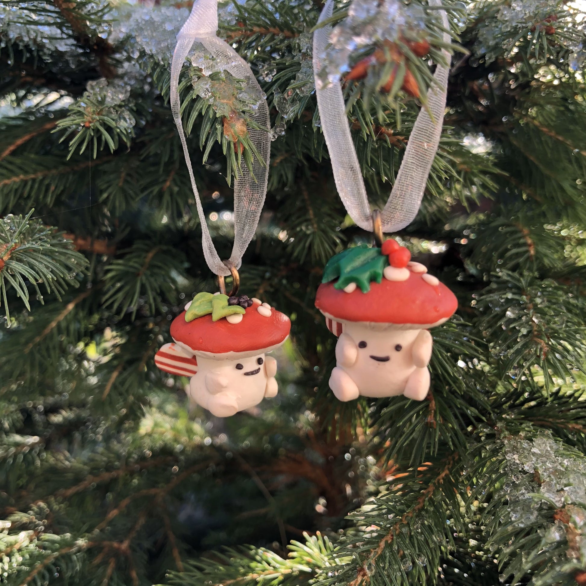 Introducing our Holly & Ivy cute candy cane winged Mushroom charms handmade in polymer clay, to dangle as home decor or thread on a cord to wear as a necklace