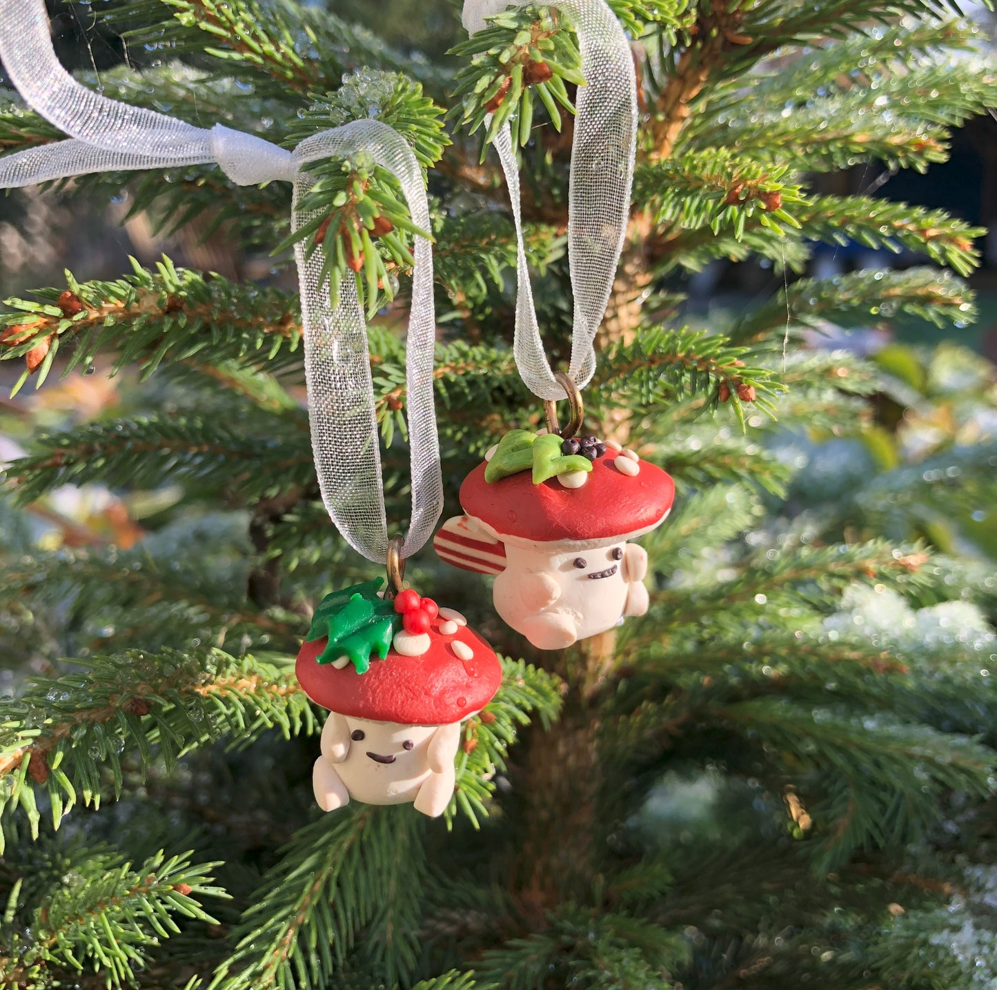 Introducing our Holly & Ivy cute candy cane winged Mushroom charms handmade in polymer clay, to dangle as home decor or thread on a cord to wear as a necklace