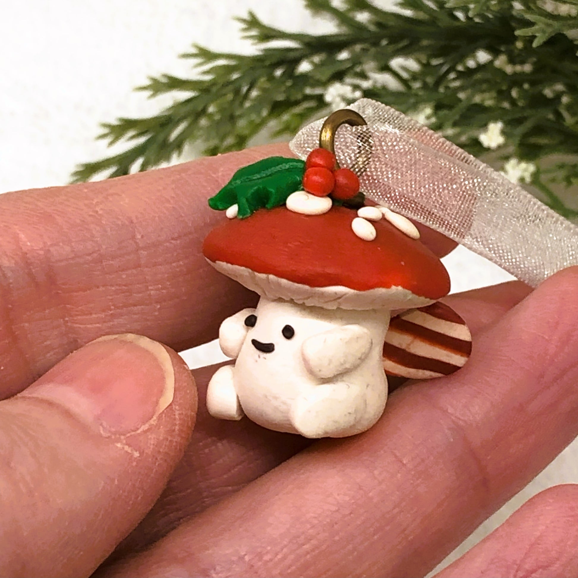 Introducing our Holly & Ivy cute candy cane winged Mushroom charms handmade in polymer clay, to dangle as home decor or thread on a cord to wear as a necklace