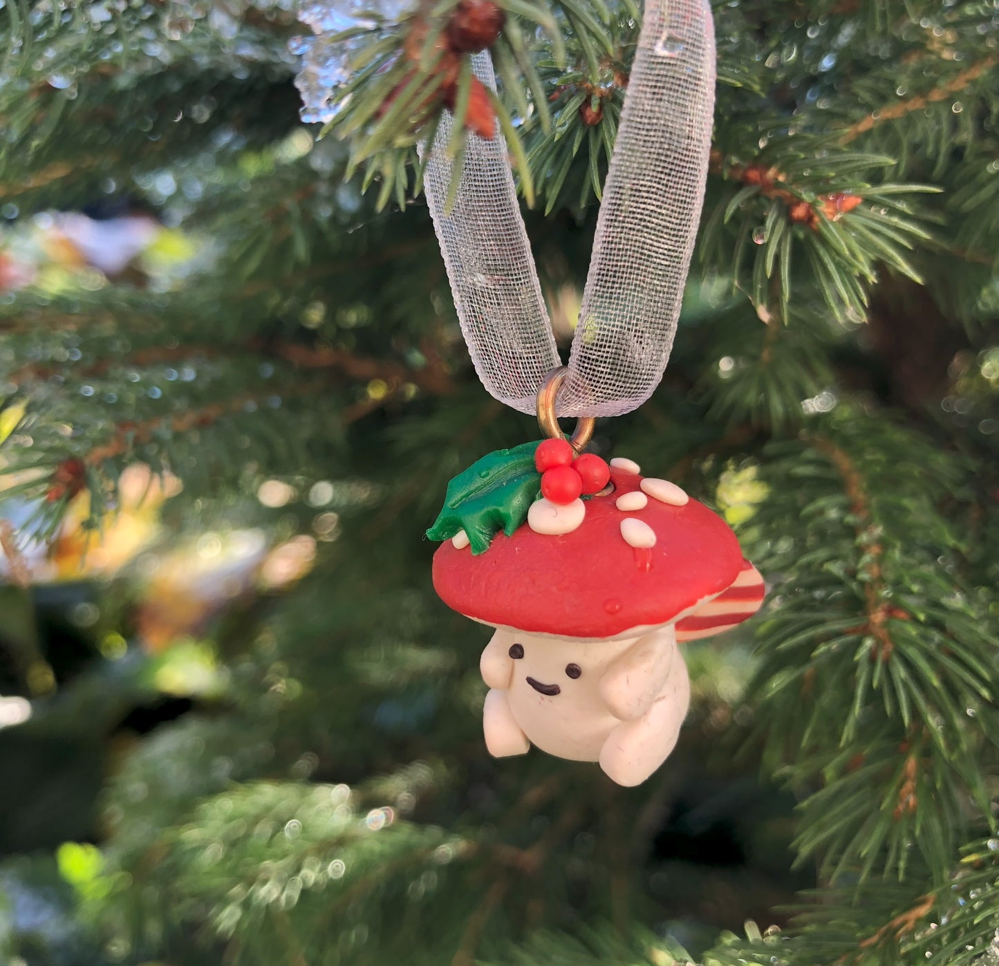 Introducing our Holly & Ivy cute candy cane winged Mushroom charms handmade in polymer clay, to dangle as home decor or thread on a cord to wear as a necklace