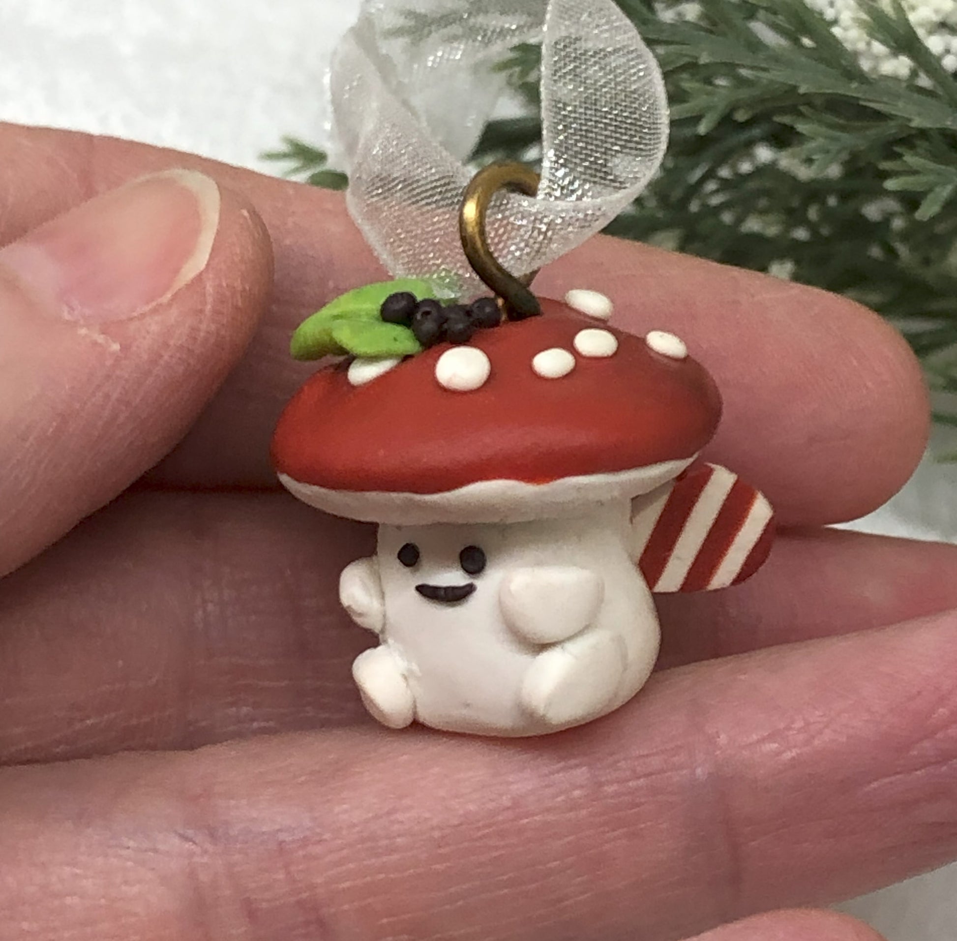 Introducing our Holly & Ivy cute candy cane winged Mushroom charms handmade in polymer clay, to dangle as home decor or thread on a cord to wear as a necklace