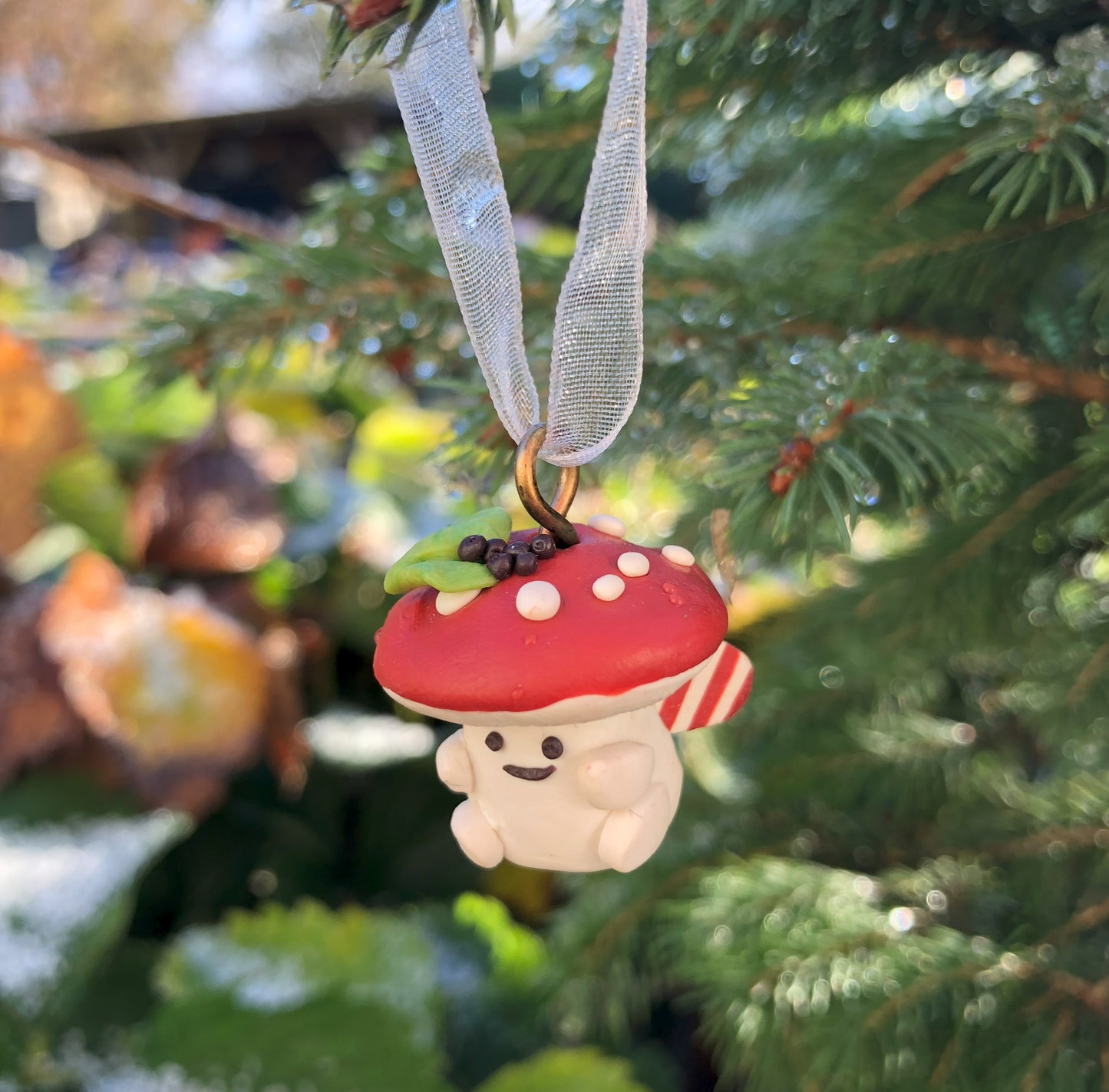 Introducing our Holly & Ivy cute candy cane winged Mushroom charms handmade in polymer clay, to dangle as home decor or thread on a cord to wear as a necklace