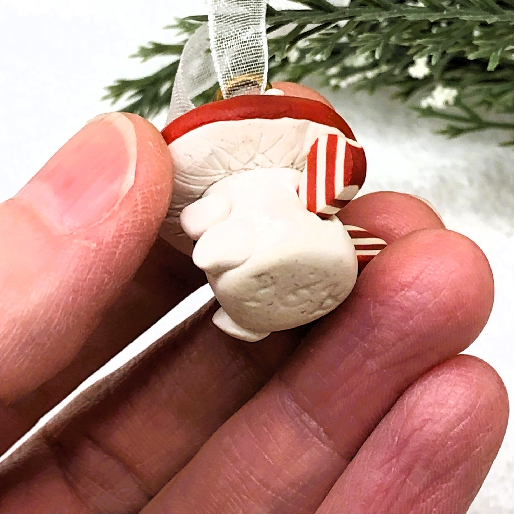 Introducing our Holly & Ivy cute candy cane winged Mushroom charms handmade in polymer clay, to dangle as home decor or thread on a cord to wear as a necklace