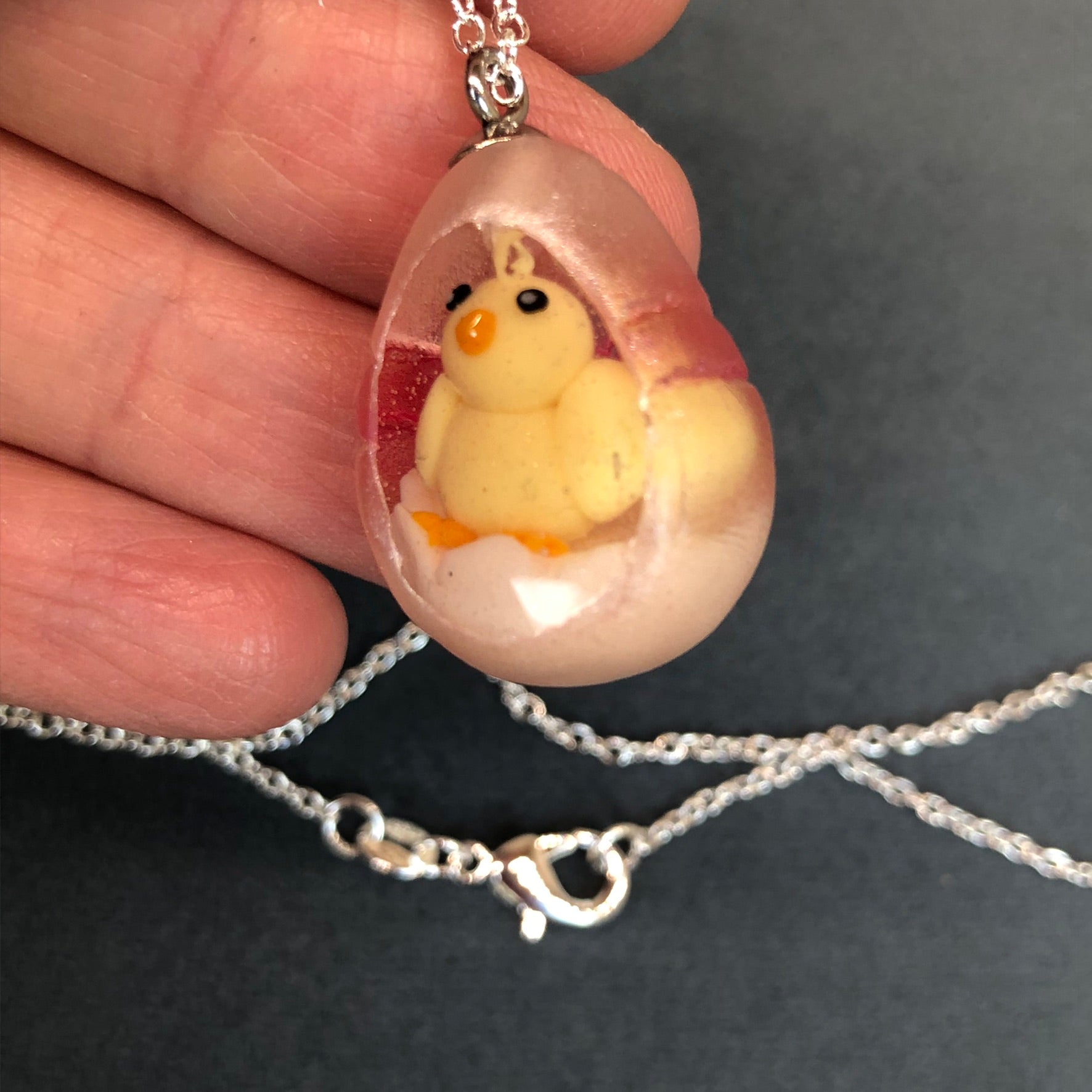 hand sculpted polymer clay chick Secret Egg necklace Ooak jewellery, my hand sculpted polymer clay chick inside hand poured epoxy resin egg which is made from my handmade silicone mold. Secret Egg nnecklacePadpodandberrieMy Fairytale Giftshand sculpted polymer clay chick inside hand poured epoxy resin egg